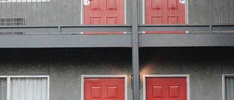 A building with two red doors, each marked with a number.