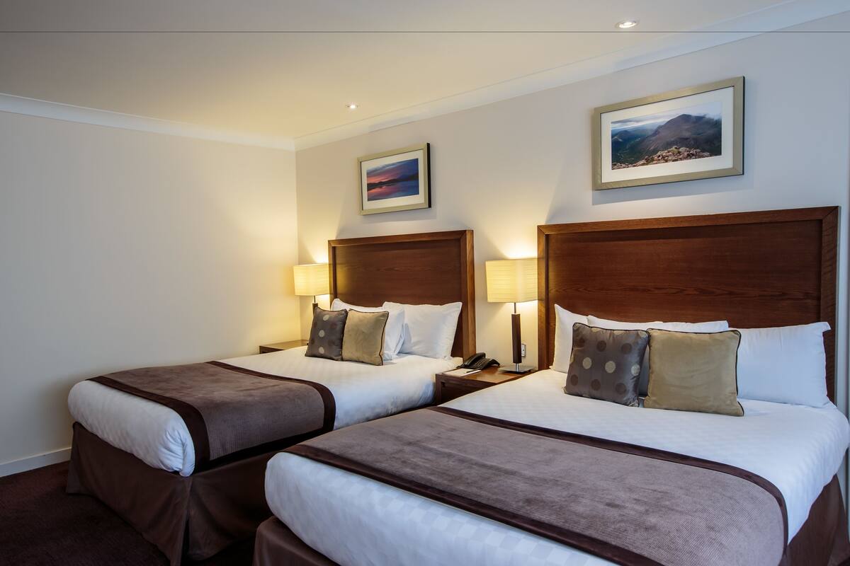 premium quadruple room, 2 double beds | in-room safe, desk, iron/ironing board, free wifi