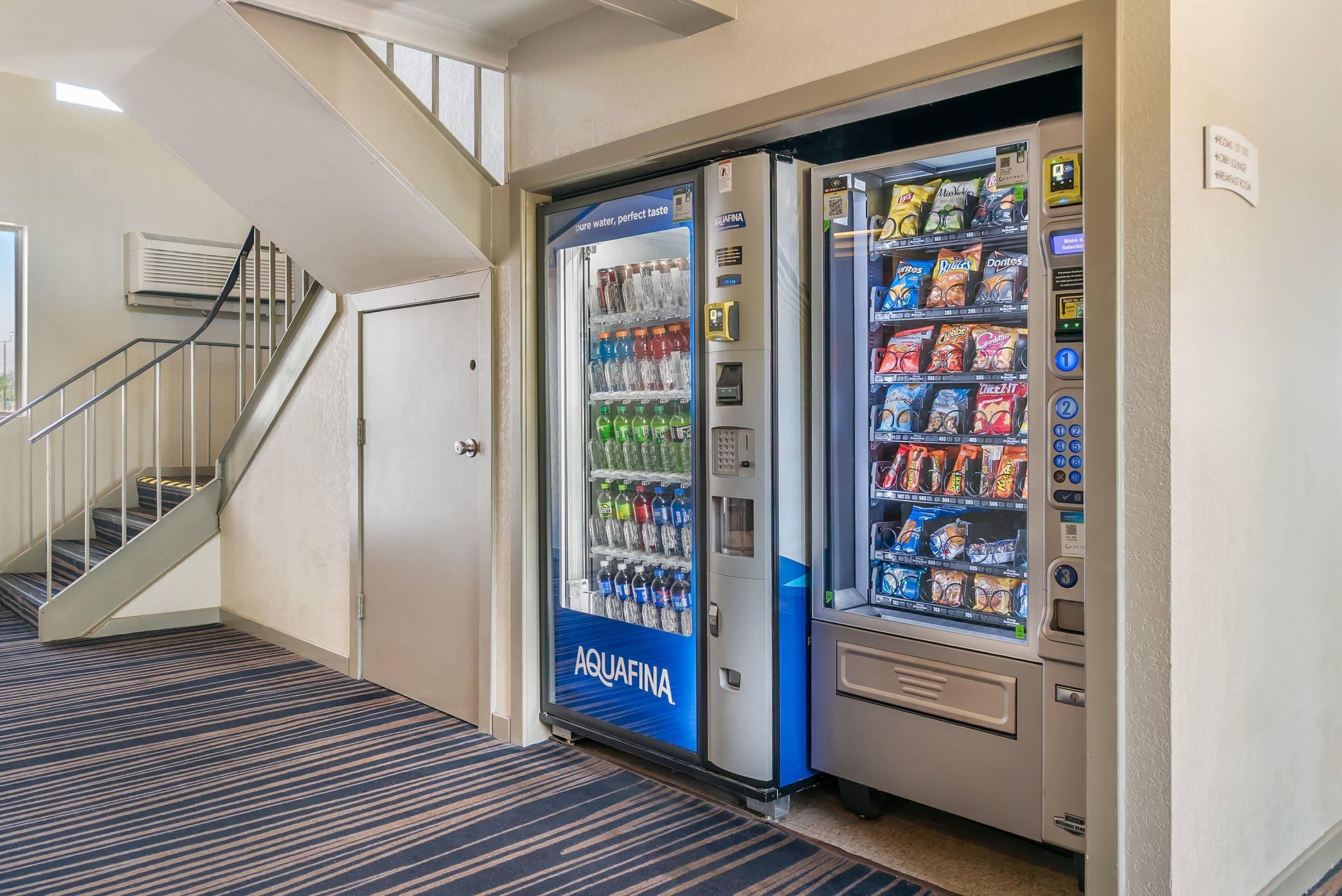 A vending machine area with a water dispenser and snack vending machines.