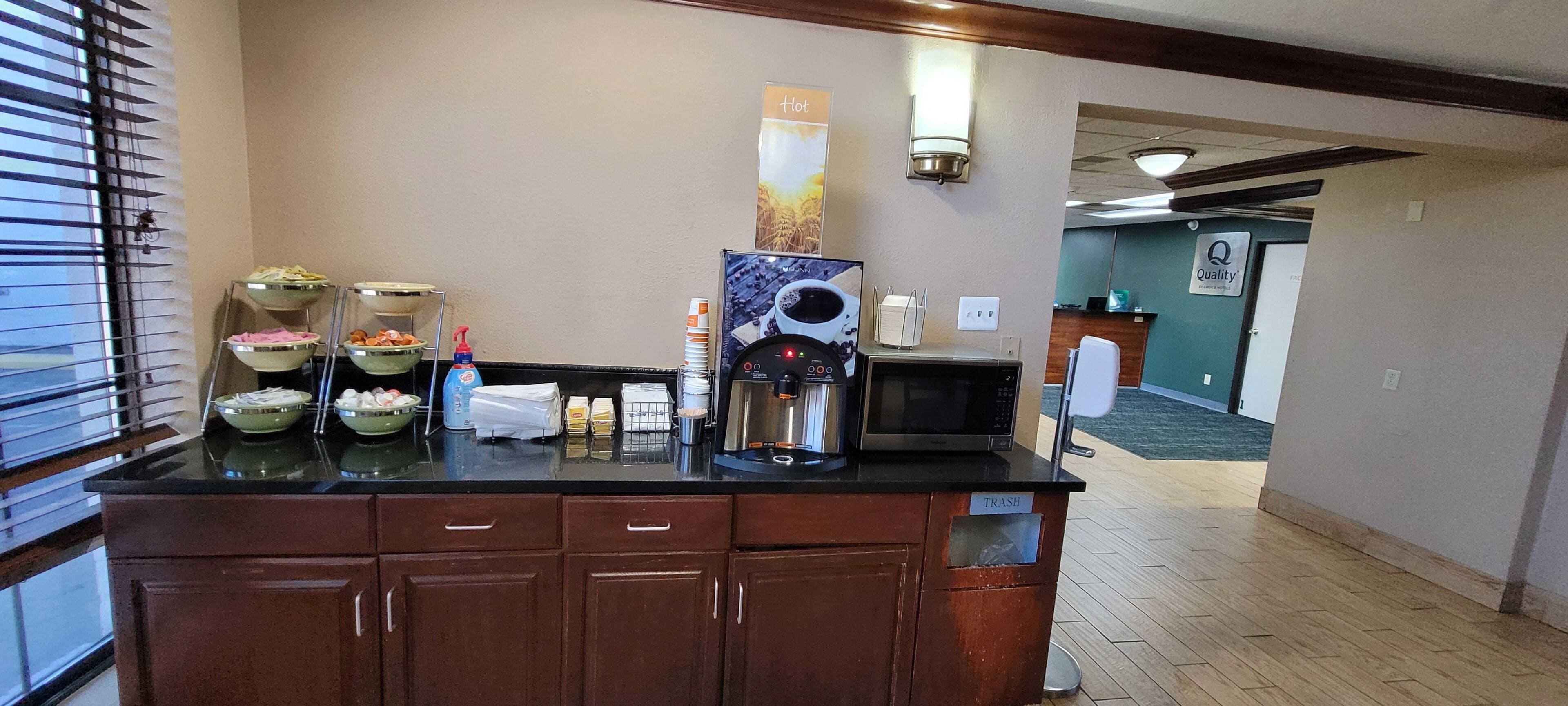 A kitchenette area with a coffee machine, microwave, and various food containers.