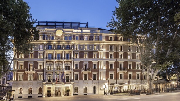 A multi-story hotel with a grand entrance, multiple balconies, and a well-lit facade. - InterContinental Rome Ambasciatori Palace by IHG (Rome)