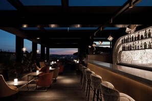 An outdoor bar area with seating and a bar counter.