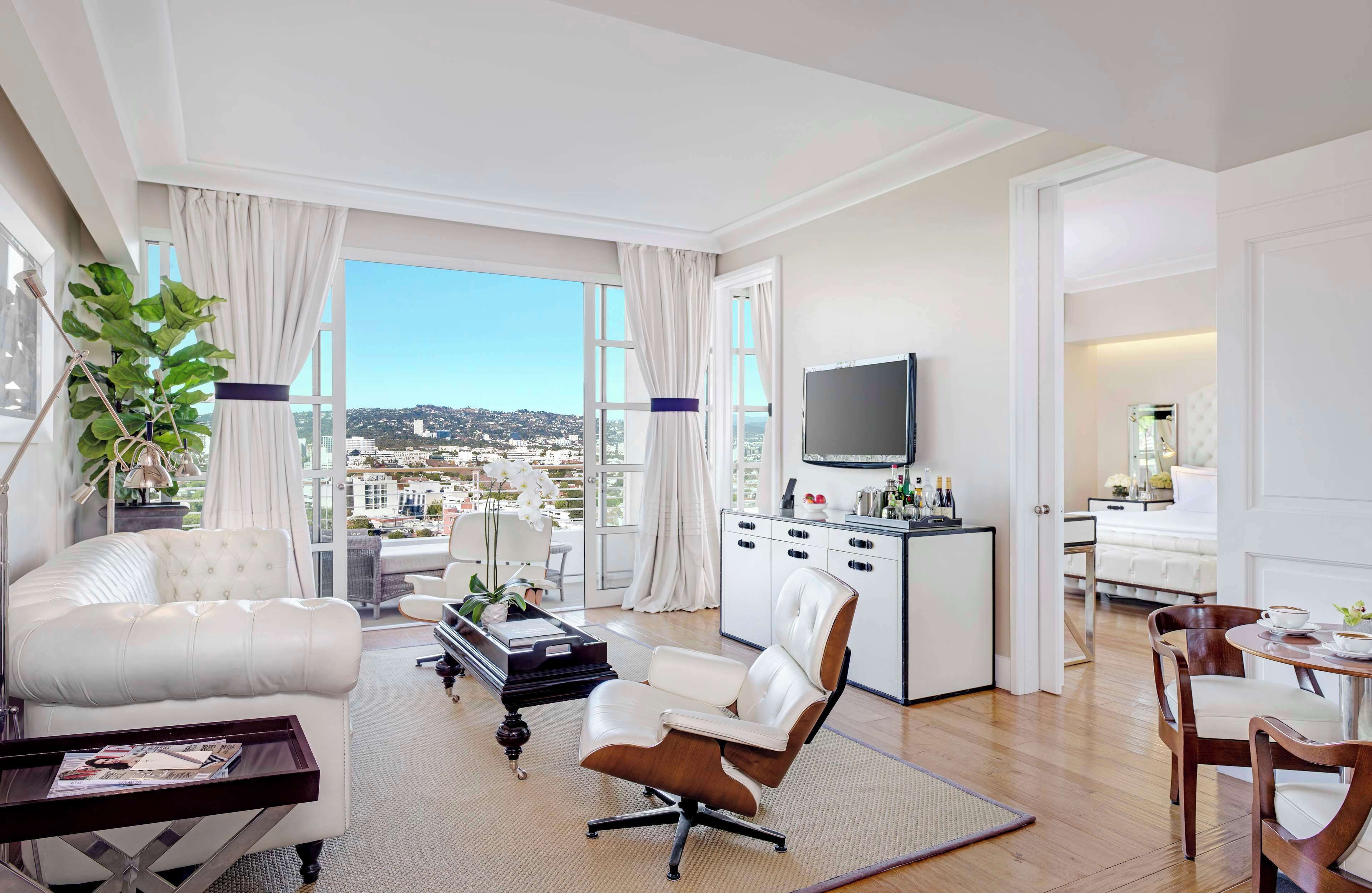 suite, 1 king bed, balcony (beverly hills) | living area | 42-inch flat-screen tv with cable channels, tv, ipod dock