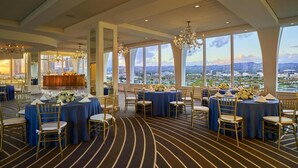 A banquet hall with round tables, gold chairs, and chandeliers. - Cameo Beverly Hills, LXR Hotels & Resorts (Los Angeles)