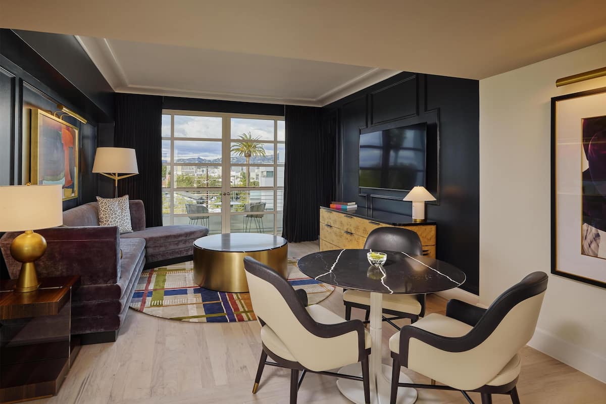 A modern living room with a sofa, a round coffee table, and a TV.