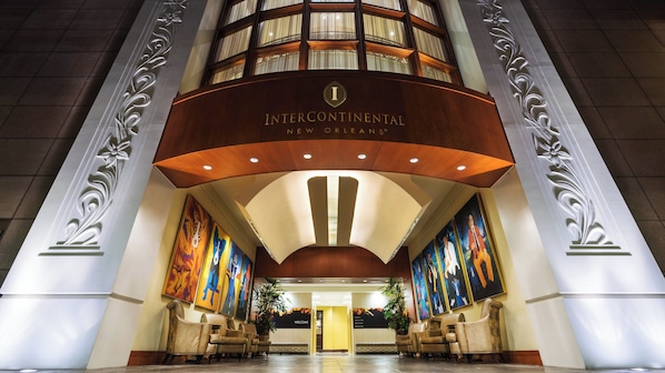The Intercontinental New Orleans hotel entrance with a grand facade, large windows, and a welcoming interior. - InterContinental New Orleans by IHG (New Orleans)