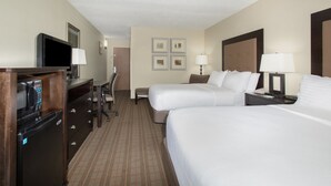 A hotel room with two beds, a desk with a computer, a television, and a refrigerator. - Holiday Inn Riverton by IHG (Riverton)
