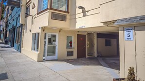 A building with a sign for 'San Francisco Inn' and a speed limit sign of 5 MPH. - San Francisco Inn (San Francisco)