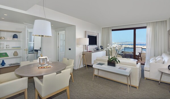 Enjoy a spacious room with a dining area, living space, and a large window offering a view of the sea and distant land.