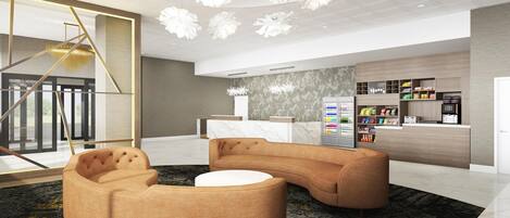 A modern lobby with a reception desk, vending machines, and a seating area with a round coffee table.
