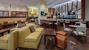A hotel lobby with seating areas, a bar, and large windows. - Provo Marriott Hotel & Conference Center (Provo)