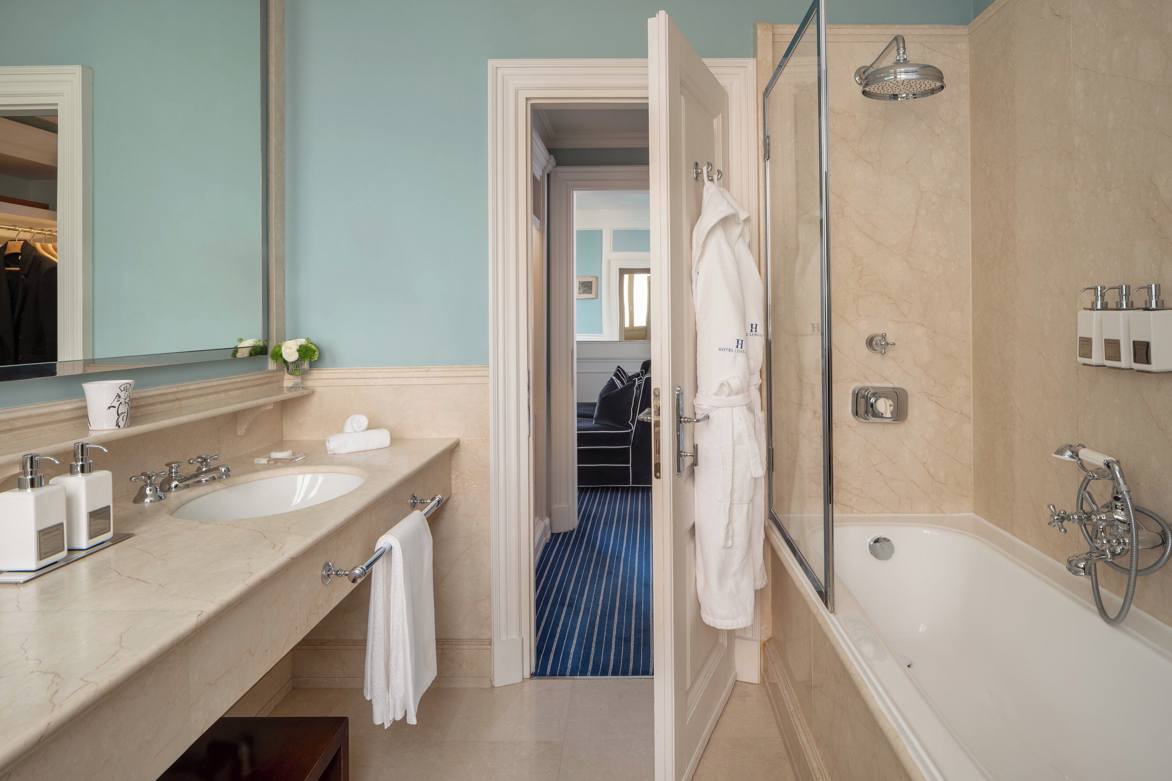 A bathroom with two sinks, a bathtub, and a shower.