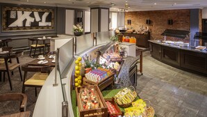 A breakfast buffet with various food items and a coffee station. - Crowne Plaza Nottingham by IHG (Nottingham)