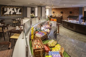 A breakfast buffet with various food items and a coffee station.
