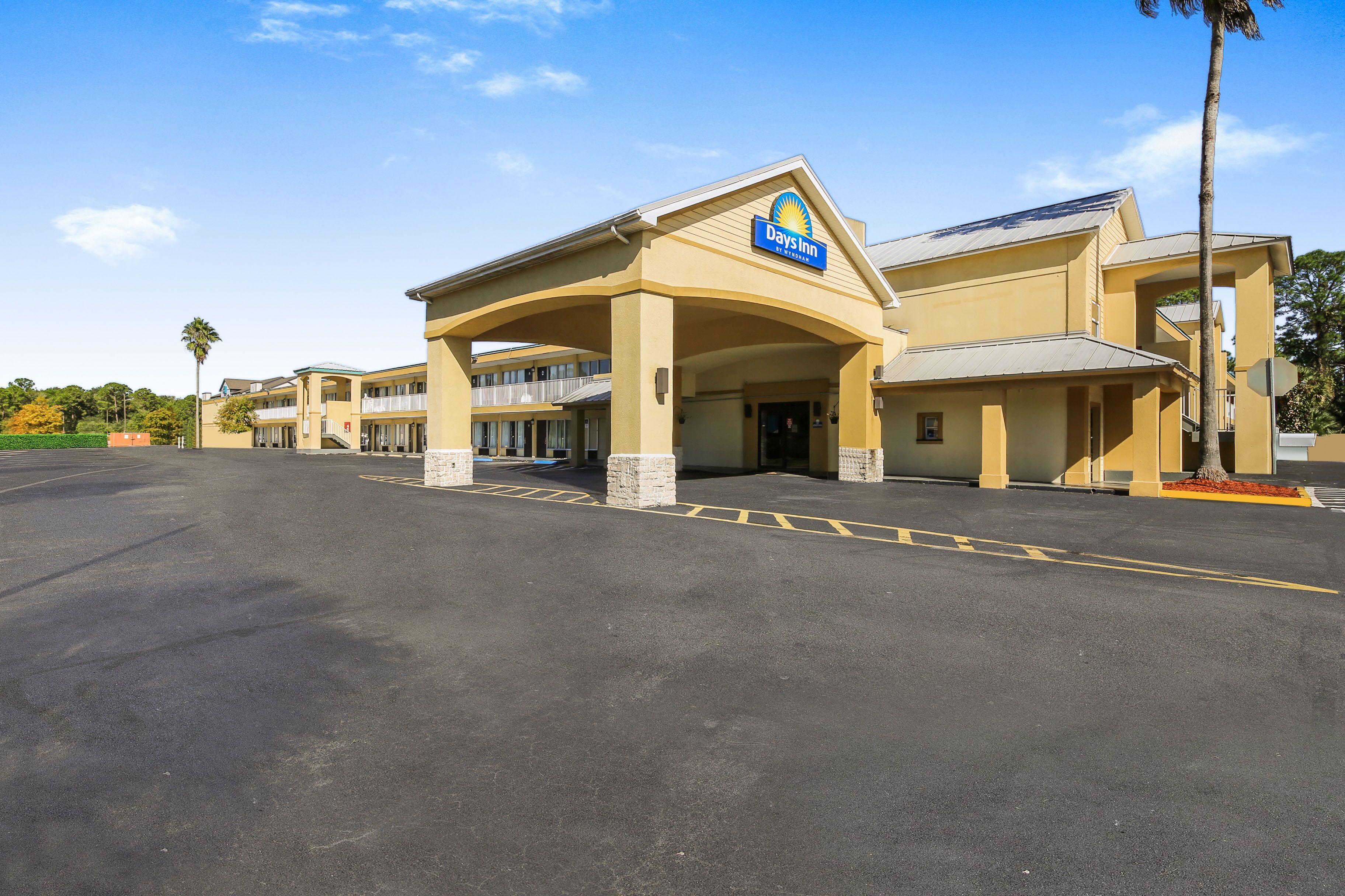 A Days Inn with a large parking lot and a two-story building.