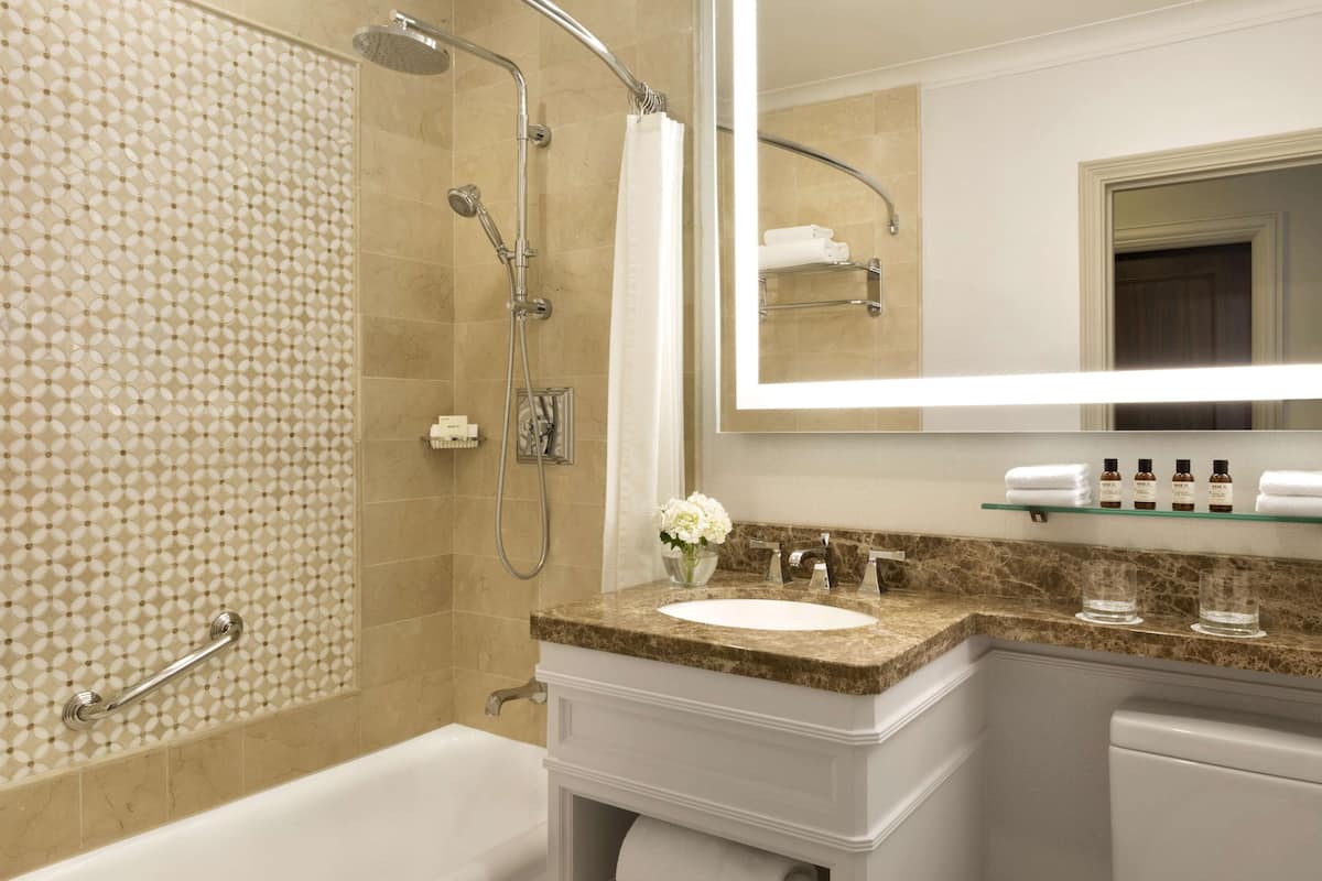 combined shower/bathtub, designer toiletries, hair dryer, bathrobes