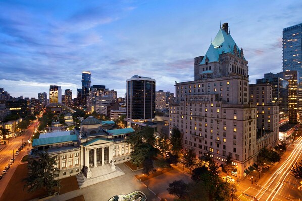A cityscape with a prominent historic building featuring a dome and a modern skyscraper nearby. - Fairmont Hotel Vancouver (Vancouver)
