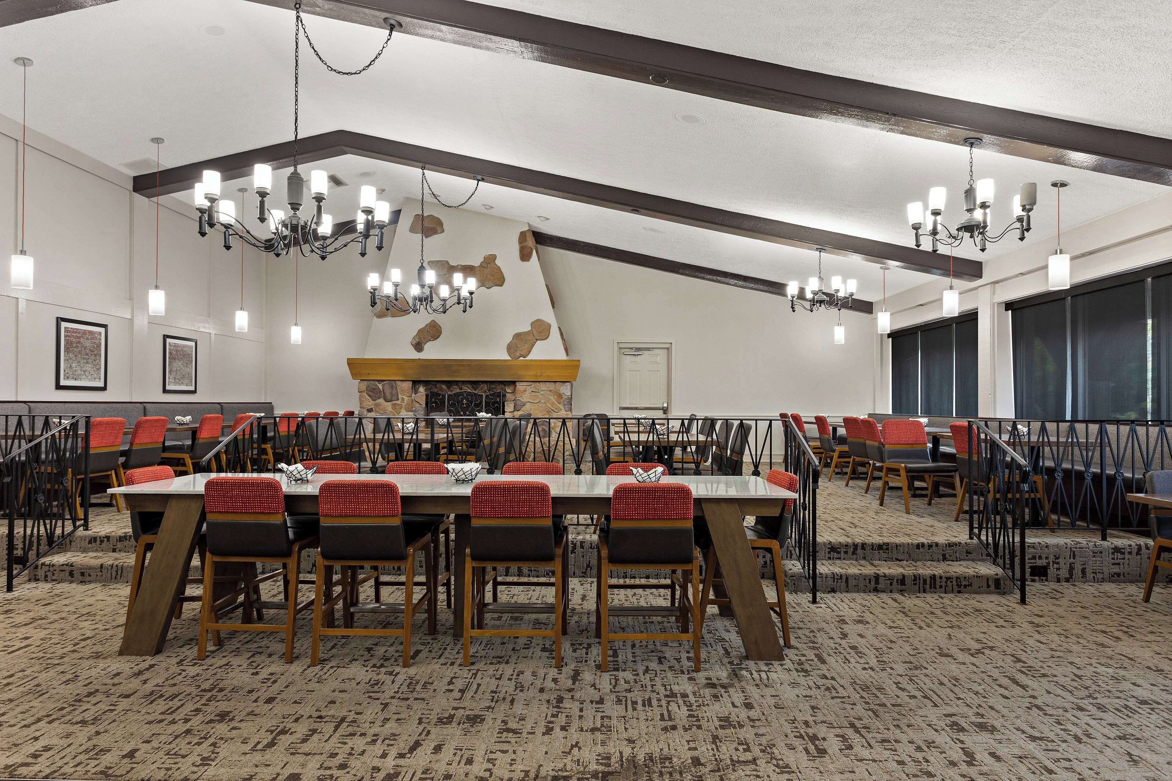 Une salle de conférence avec une longue table, de nombreuses chaises et un lustre.
