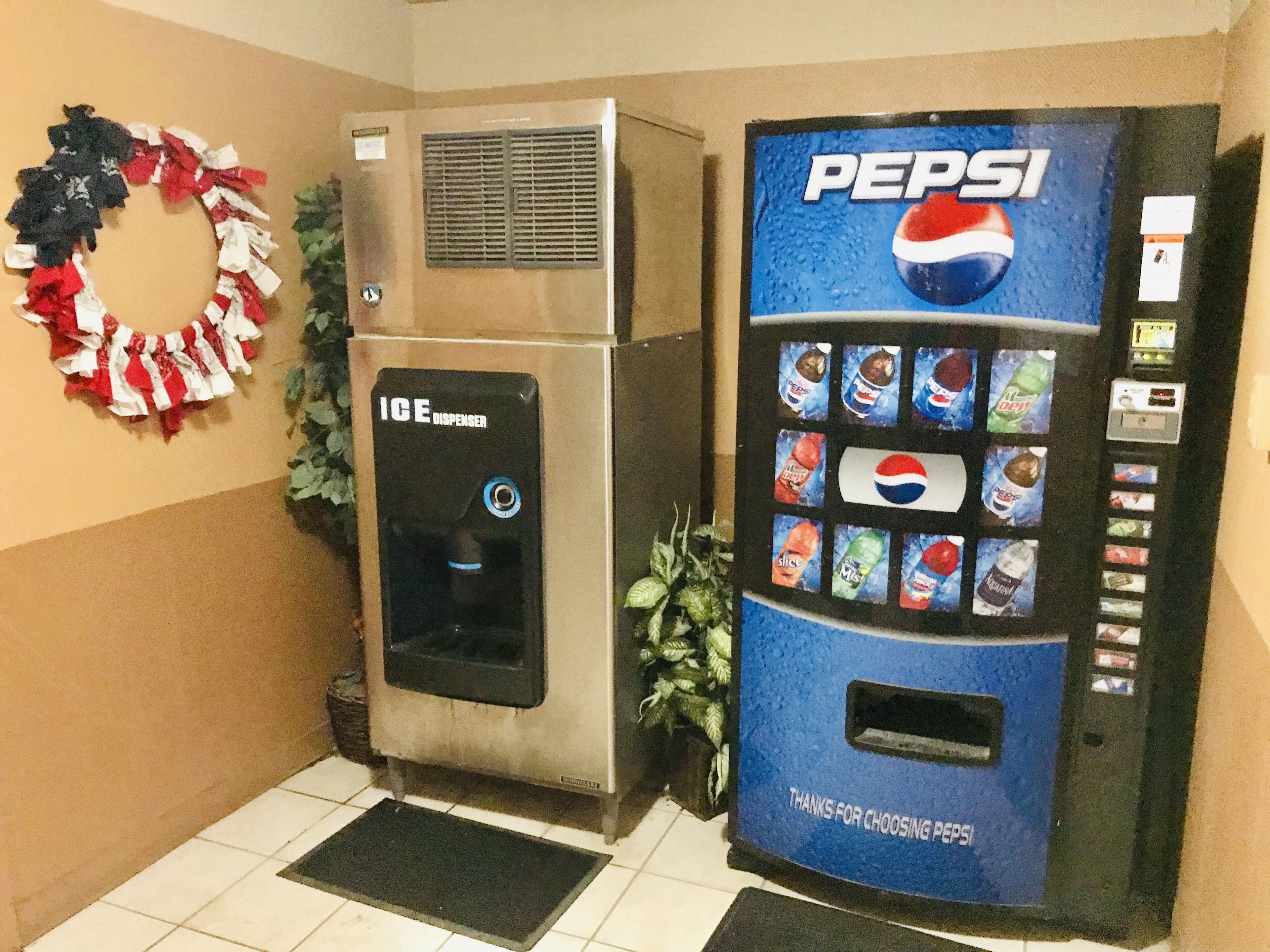 A vending machine with a Pepsi logo and a water dispenser with an ice dispenser.