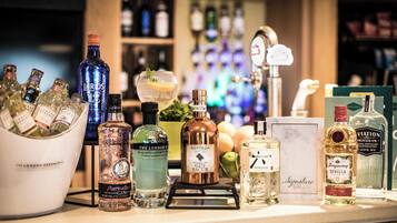 A bar counter with various bottles of gin and other spirits.