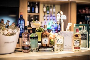 A bar counter with various bottles of gin and other spirits. - Holiday Inn Slough - Windsor by IHG (Slough)
