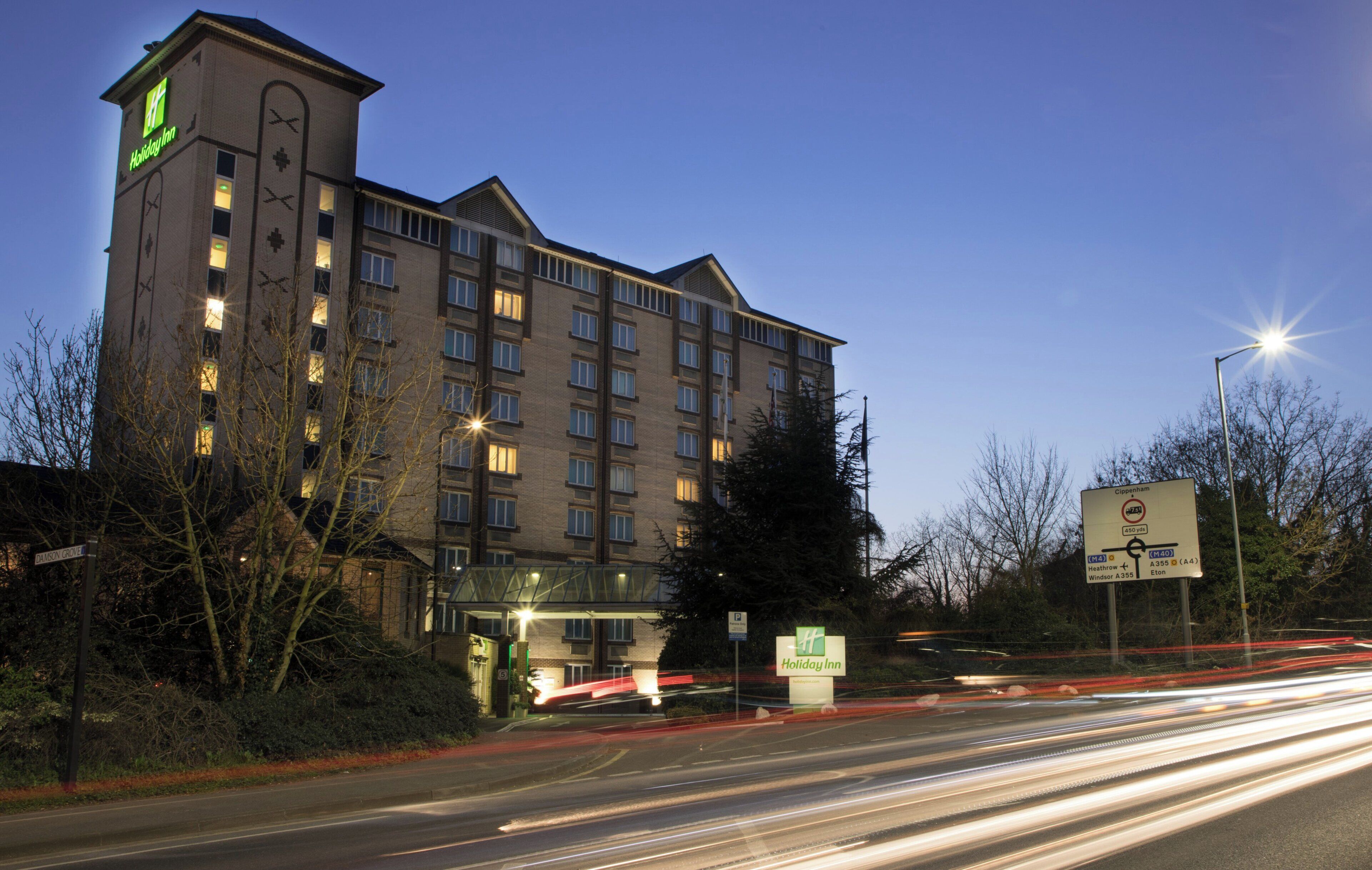 A Holiday Inn hotel with multiple floors, a prominent entrance, and a parking area.
