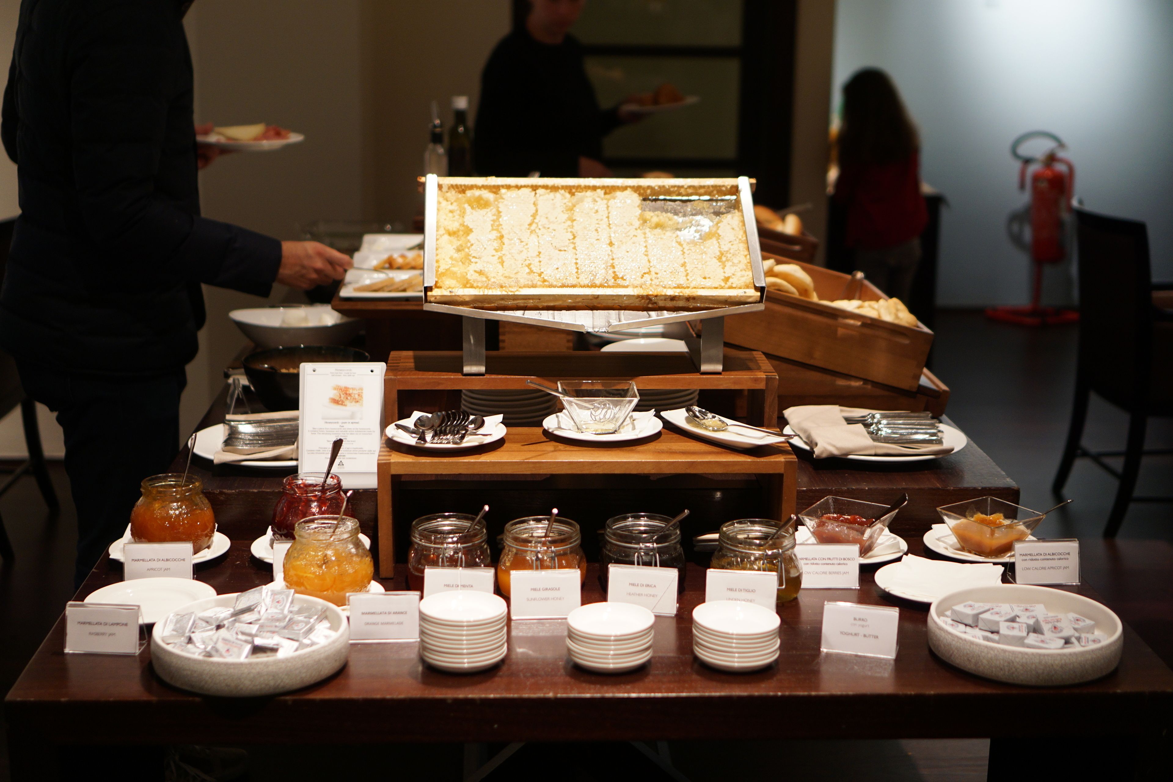 A buffet setup with various food items and utensils.