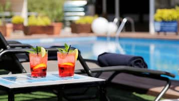 Relax by the pool with refreshing drinks and comfortable lounge chairs.