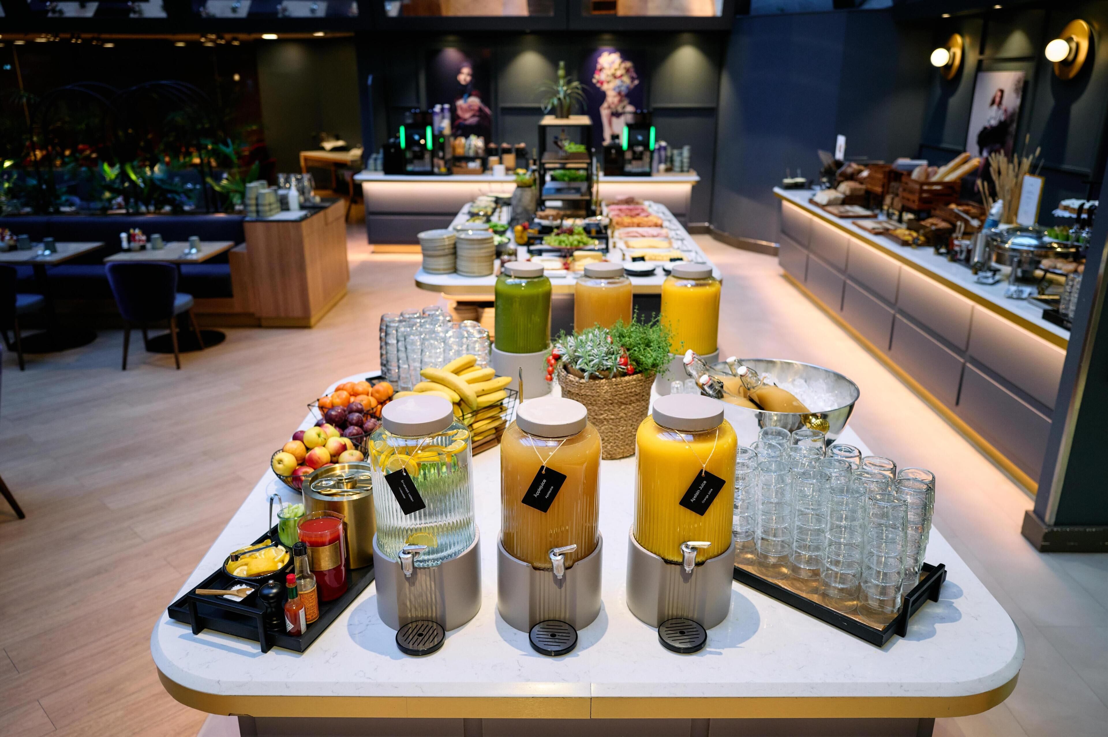 A buffet setup with various food items and beverages.
