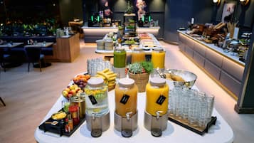A buffet setup with various food items and beverages.