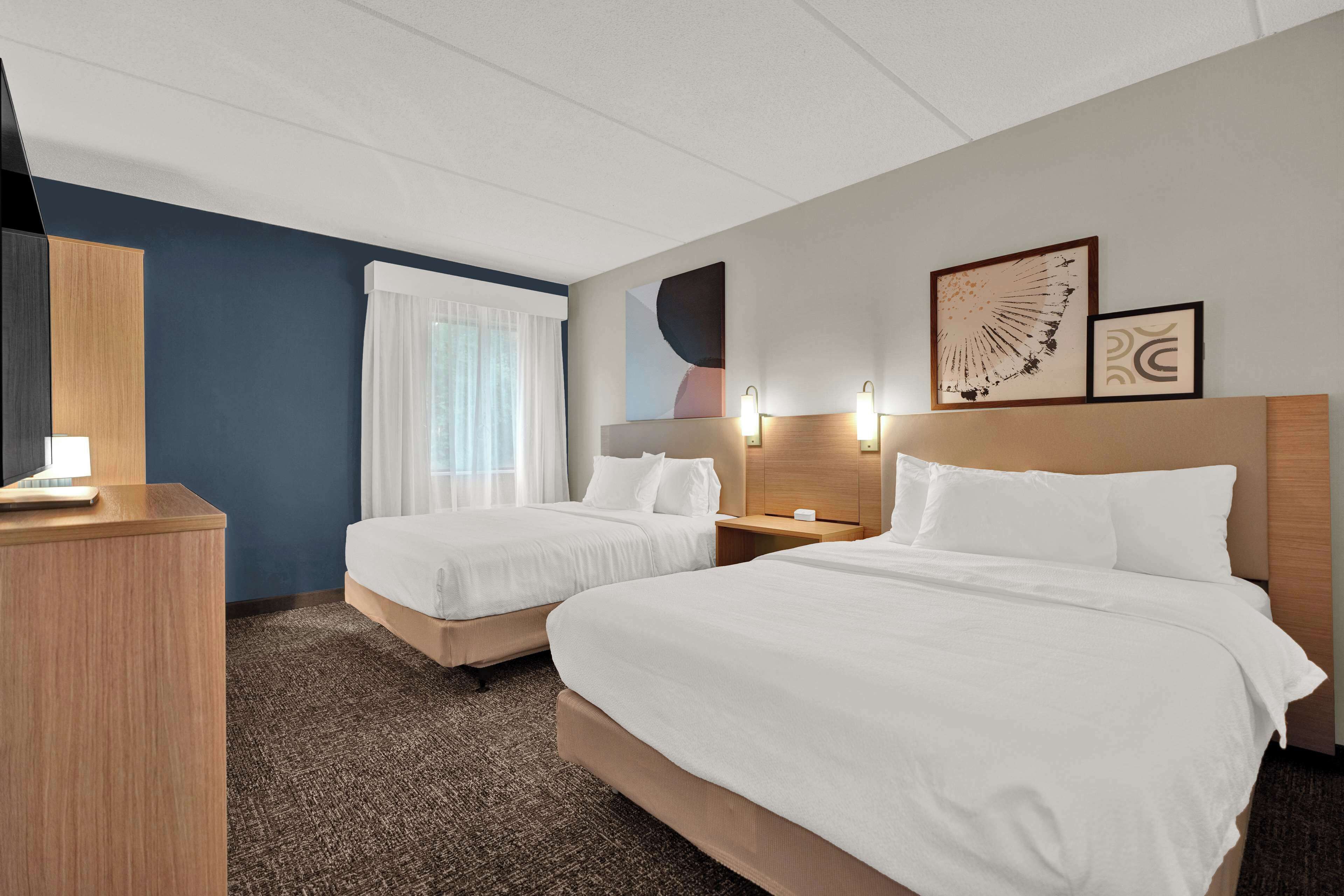 premium bedding, pillow-top beds, desk, laptop workspace