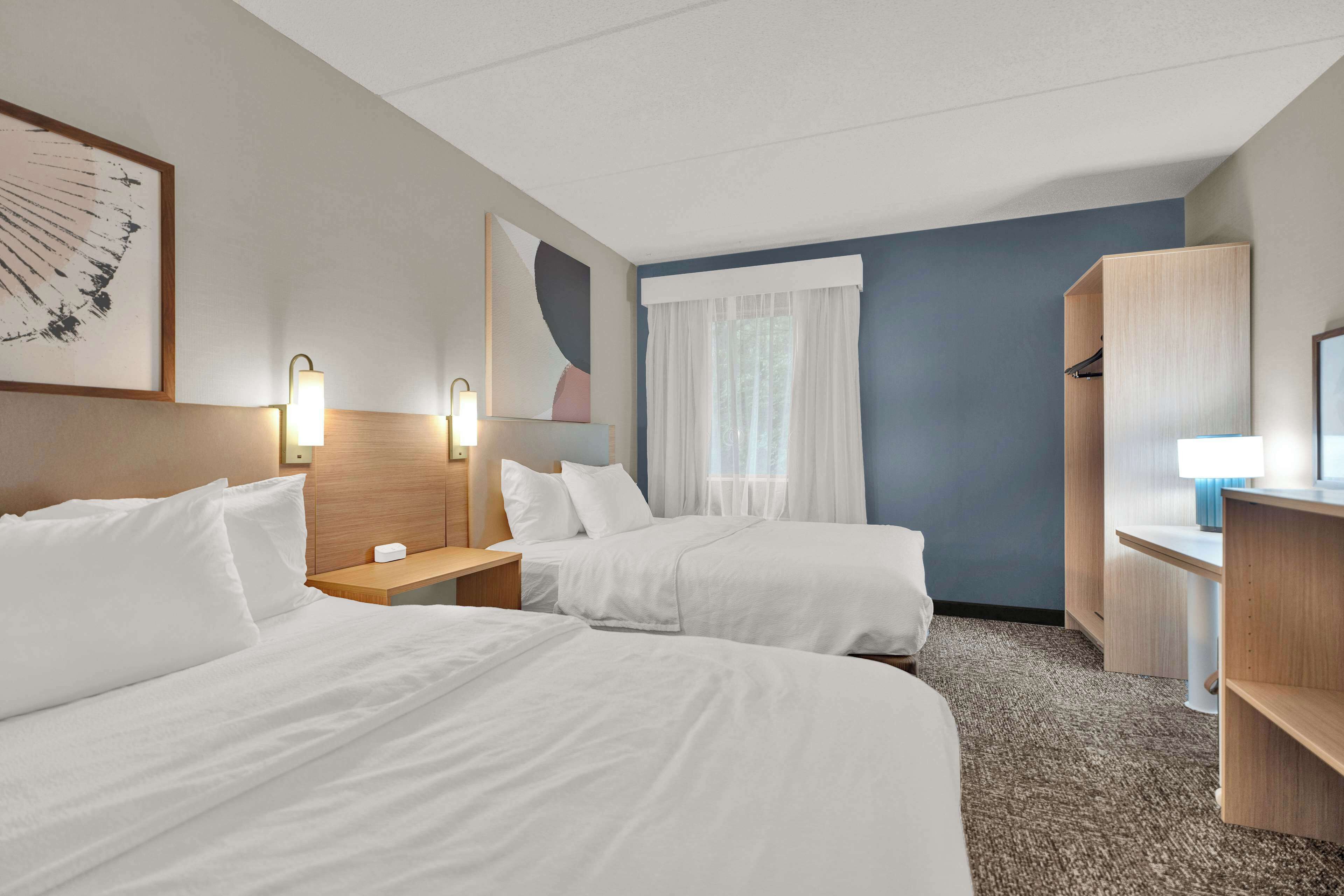 premium bedding, pillow-top beds, desk, laptop workspace