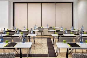 A conference room with multiple tables, chairs, and water bottles. - Sercotel Hotel Europa (San Sebastián)