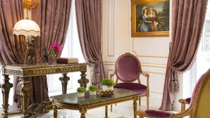 A room with a marble table, a statue, and a chair with a purple cushion. - Académie Hôtel Saint Germain (Paris)