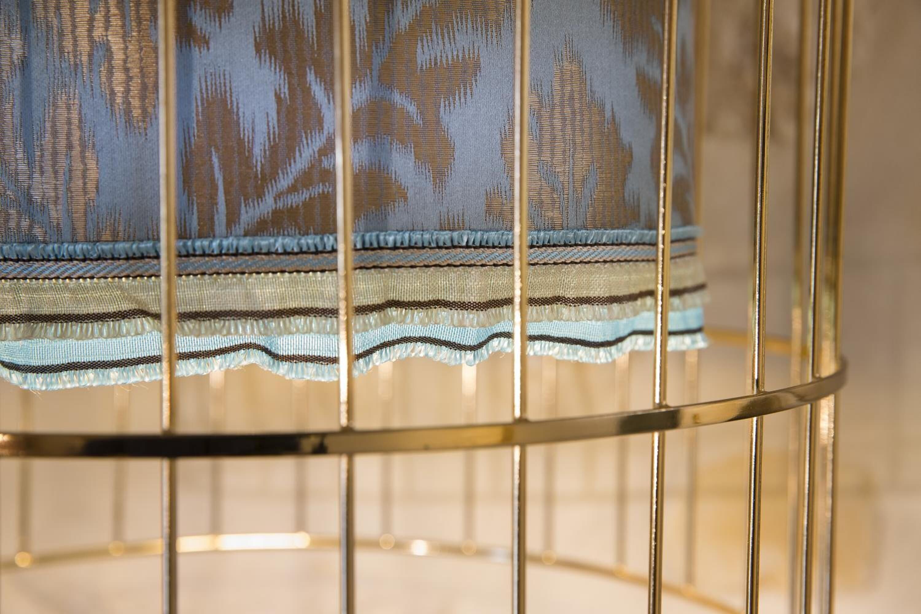 A close-up of a metal-framed chair with a patterned fabric.