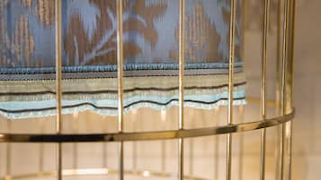 A close-up of a metal-framed chair with a patterned fabric.