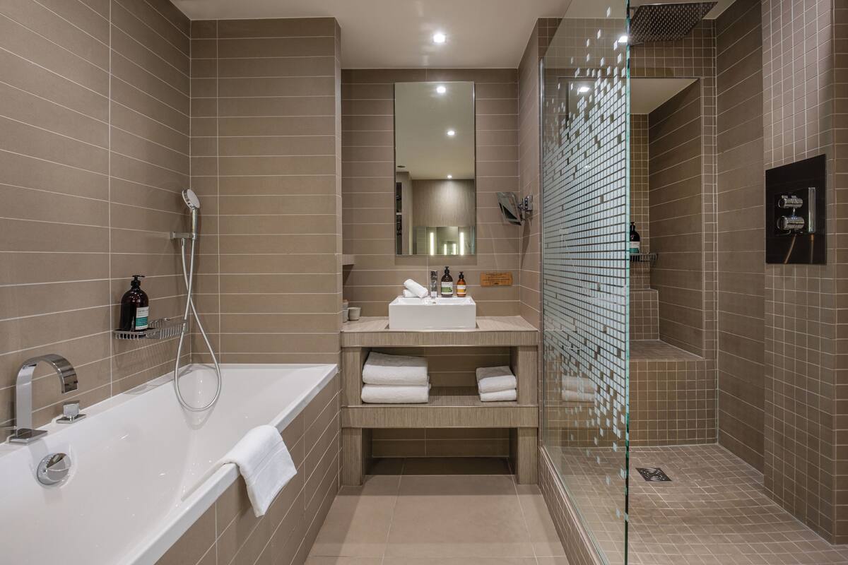 deluxe room, 1 king bed | bathroom | designer toiletries, hair dryer, bathrobes, towels