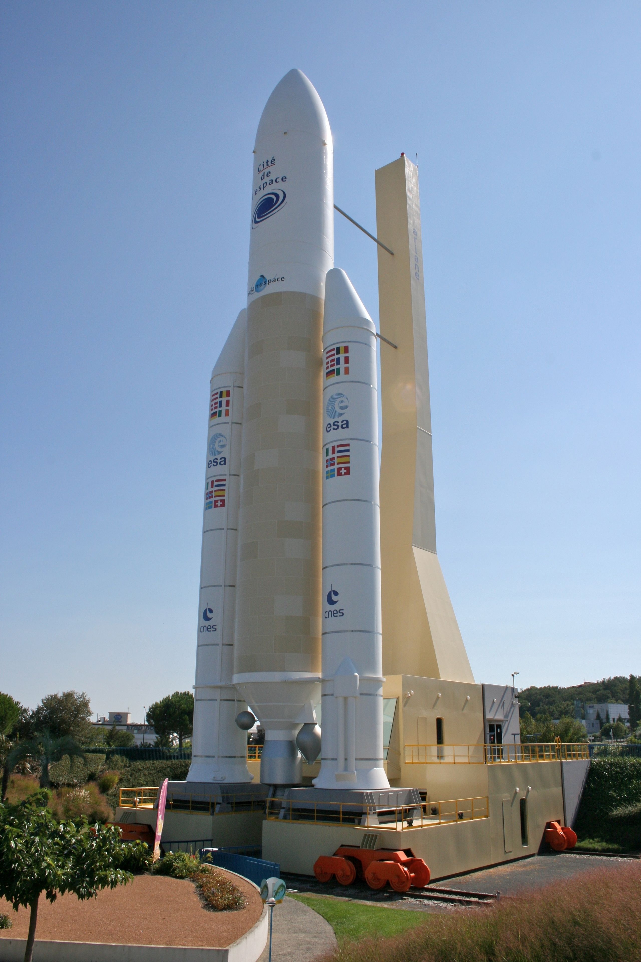 A space shuttle on display with visible logos and text indicating its association with ESA and CNES.