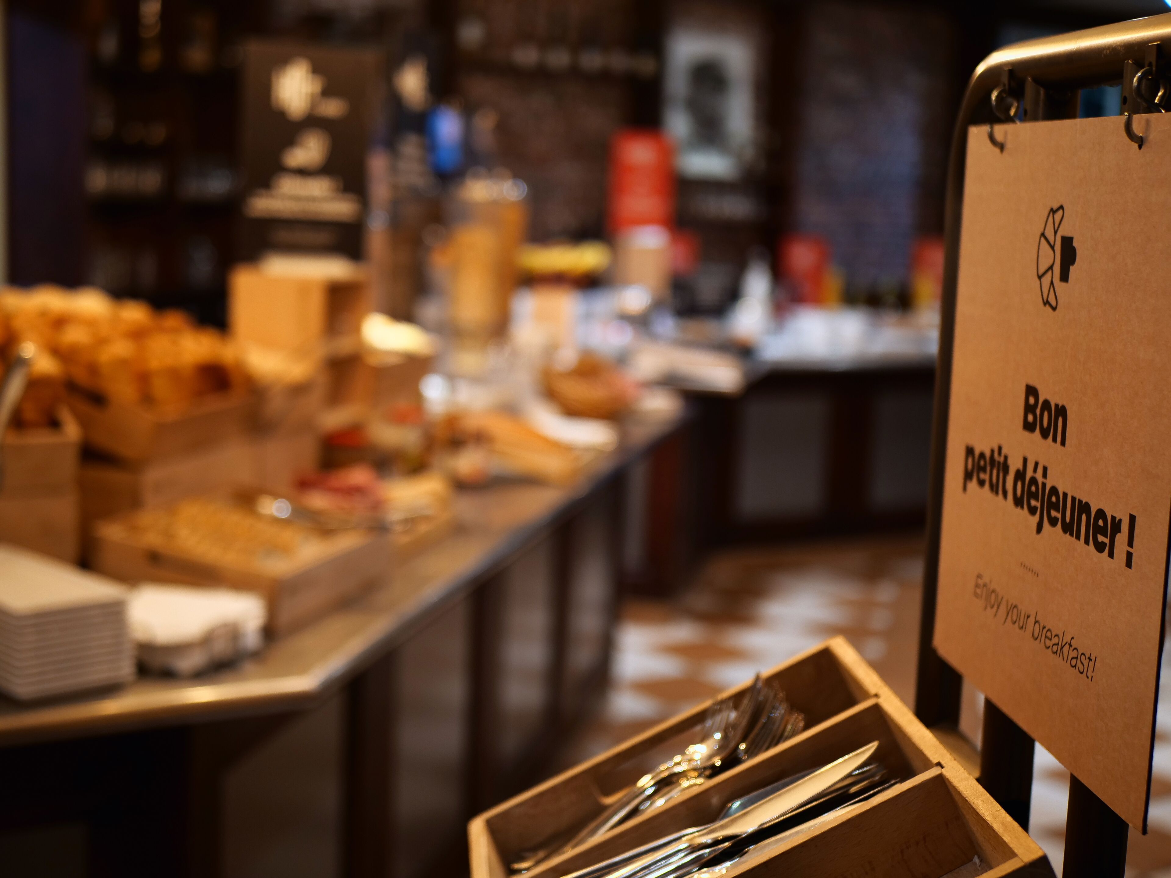 A buffet setup with various food items and utensils.