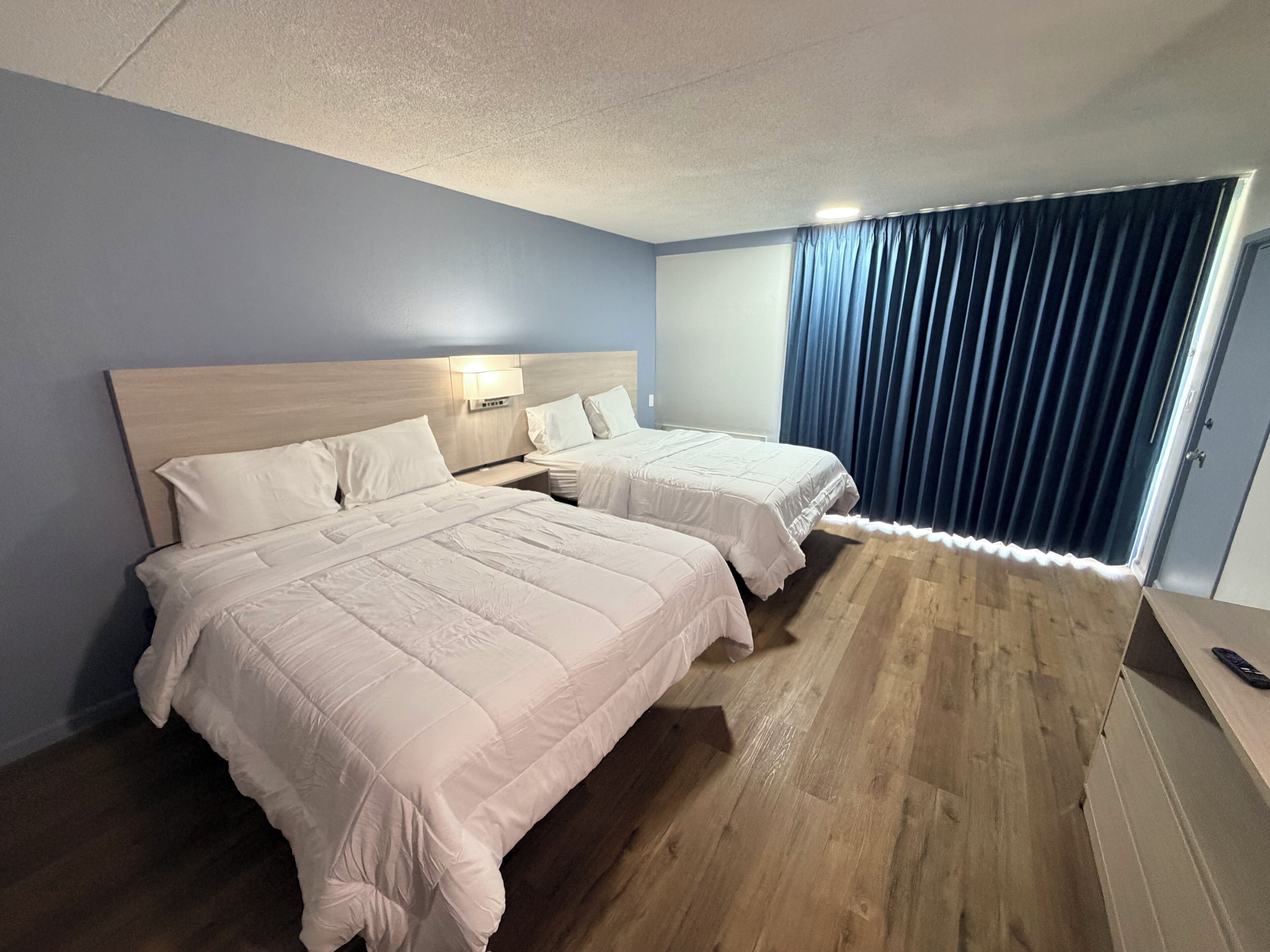 Desk, iron/ironing board, bed sheets