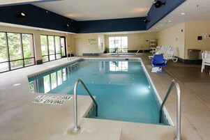 Una piscina techada, sillones reclinables de piscina