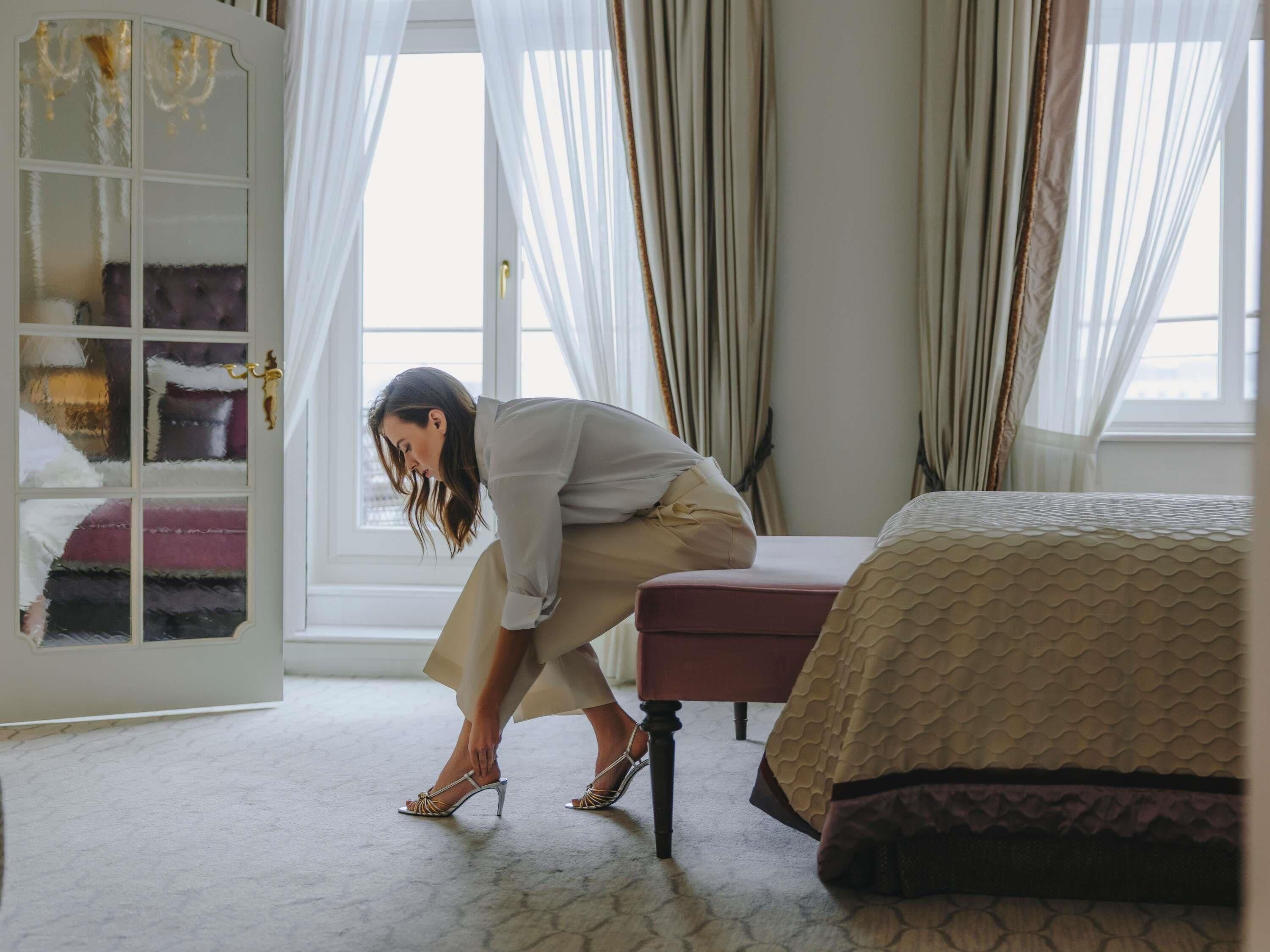 A room with a bed, a wardrobe, and a window with curtains.