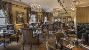 A luxurious dining area with multiple tables, elegant chairs, and chandeliers. - The Three Swans Hotel, Market Harborough, Leicestershire (Market Harborough)