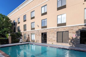 A modern building with a swimming pool, multiple windows, and a 'No Diving' sign. - Holiday Inn Express Arlington by IHG (Arlington)
