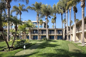 Enjoy golfing and relaxing amidst lush surroundings with a well-manicured lawn and scenic views from the hotel's balconies.