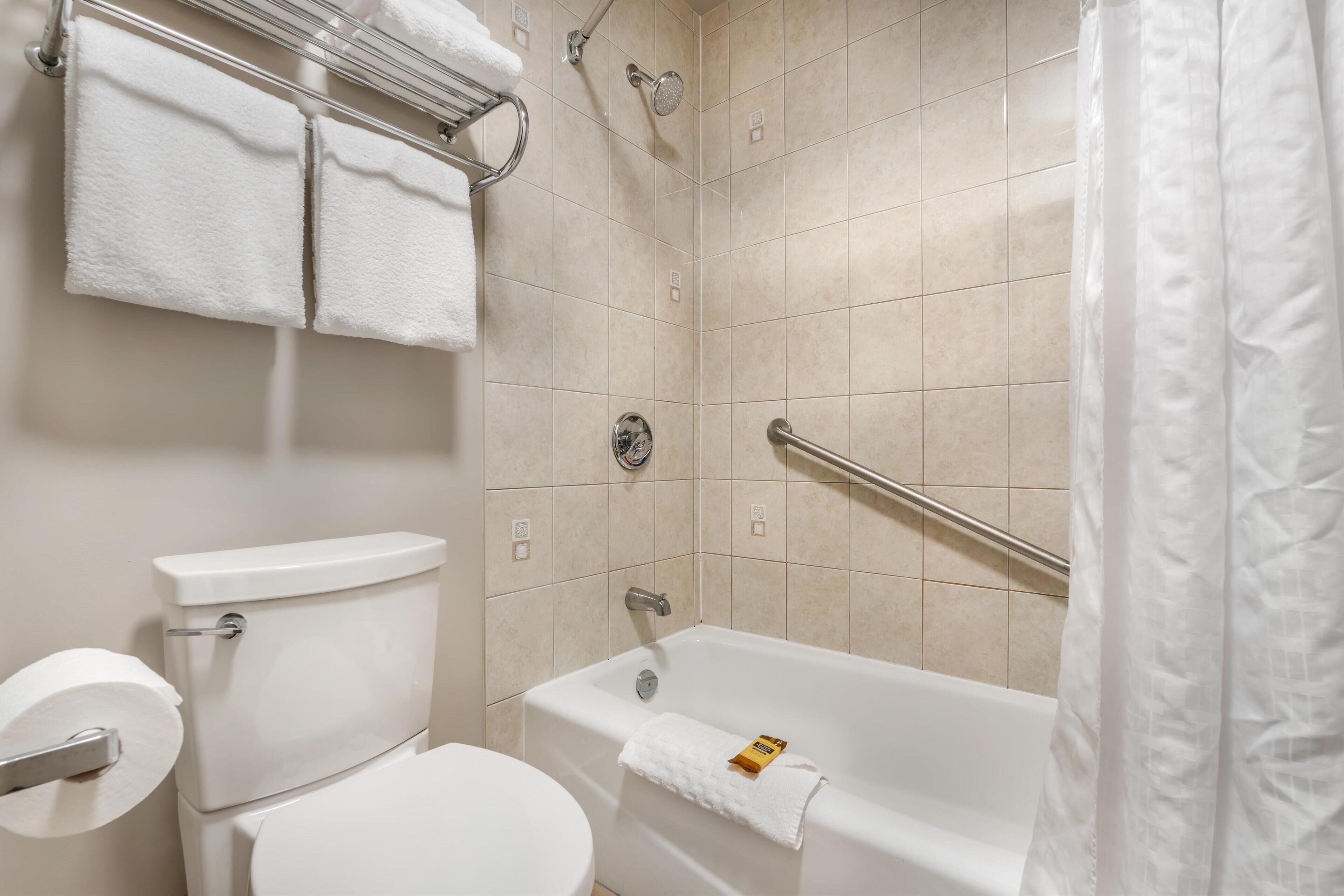 Un baño con inodoro, bañera y ducha.