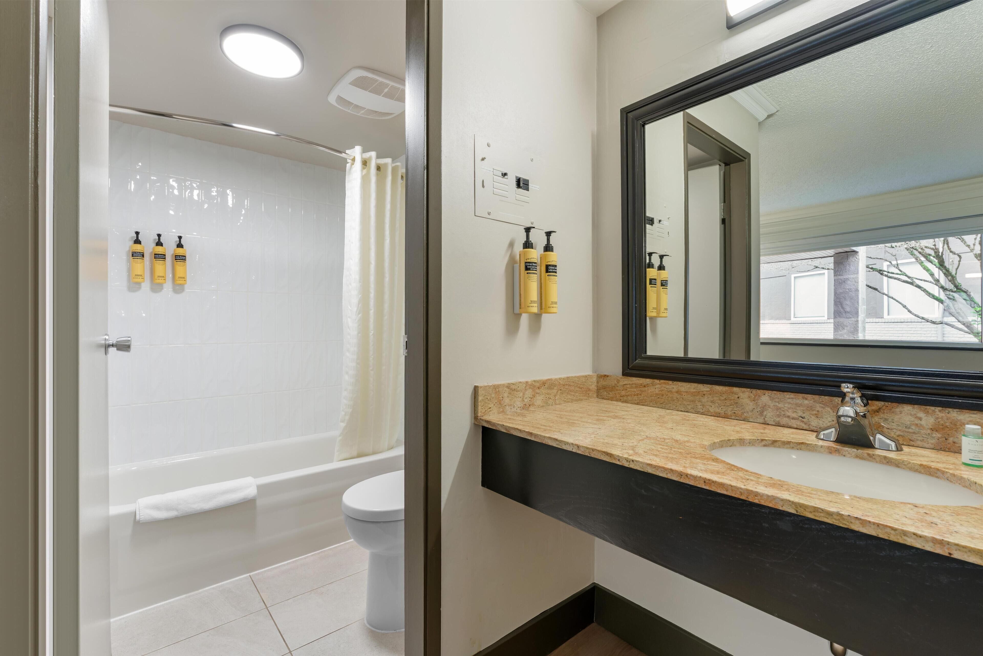 A bathroom with a bathtub, toilet, and sink.