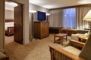 A hotel room with a bed, a desk, a television, a lamp, and a window with curtains. - DoubleTree by Hilton Libertyville - Mundelein (Mundelein)