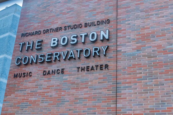 A building with a sign that reads "The Boston Conservatory Music Dance Theater."