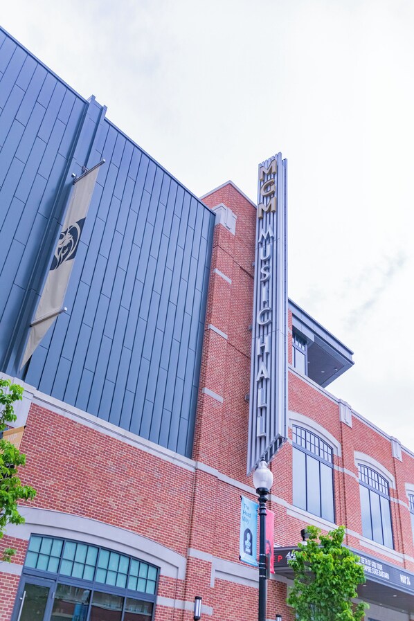 A building with a prominent 'MGM' sign, a large glass facade, and a brick exterior.
